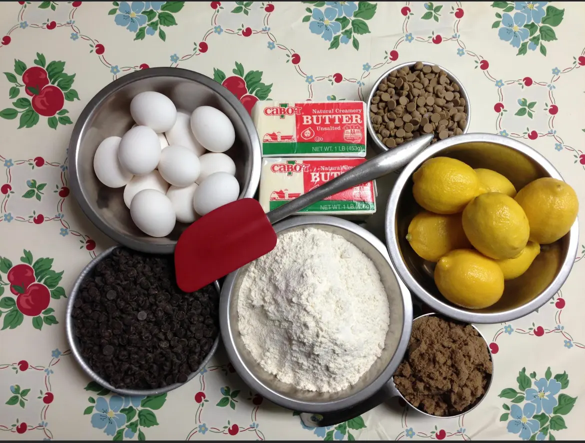Baking ingredients arranged on a floral tablecloth